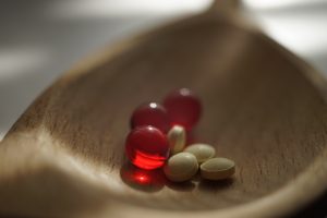 Wooden bowl with pills and vitamins. Help for addiction is possible in the Northside Indianapolis counseling center. Begin substance abuse counseling & treatment for alcoholism in Indianapolis, IN.