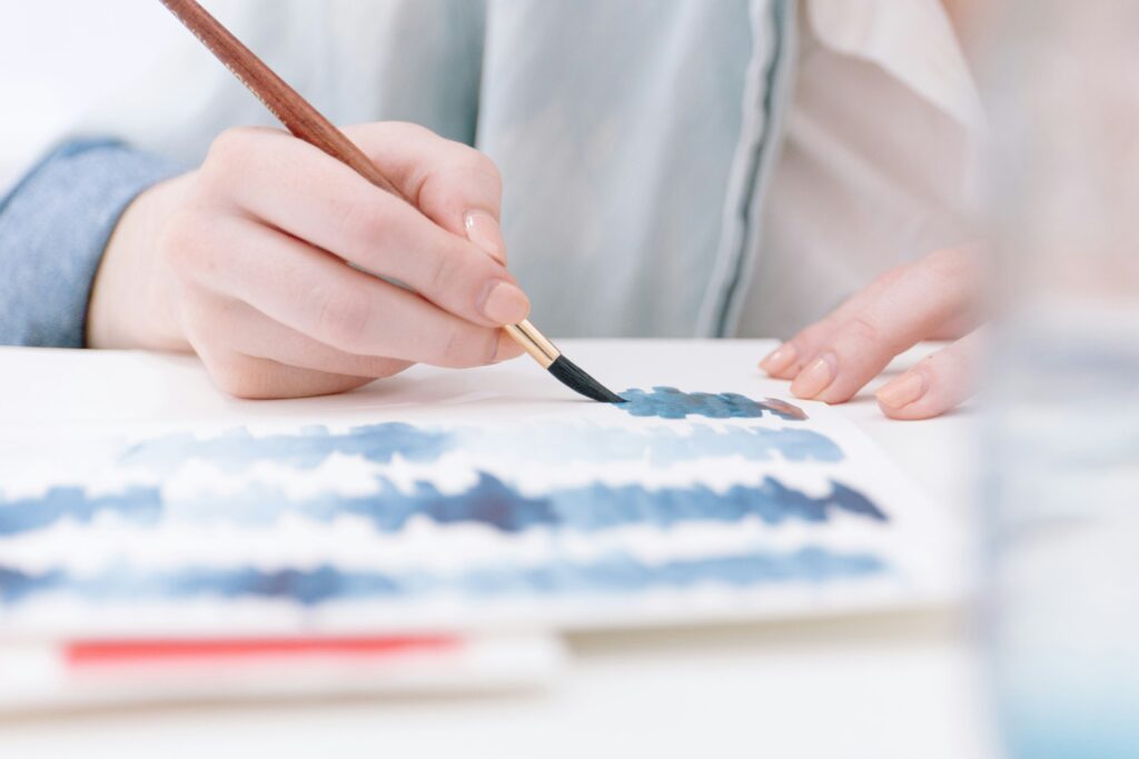 Someone painting with a paintbrush